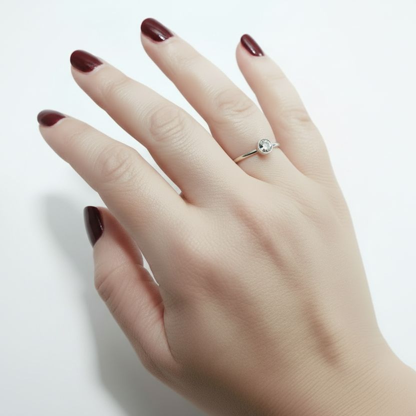 Hand wearing an ashes memorial ring with a silver stone