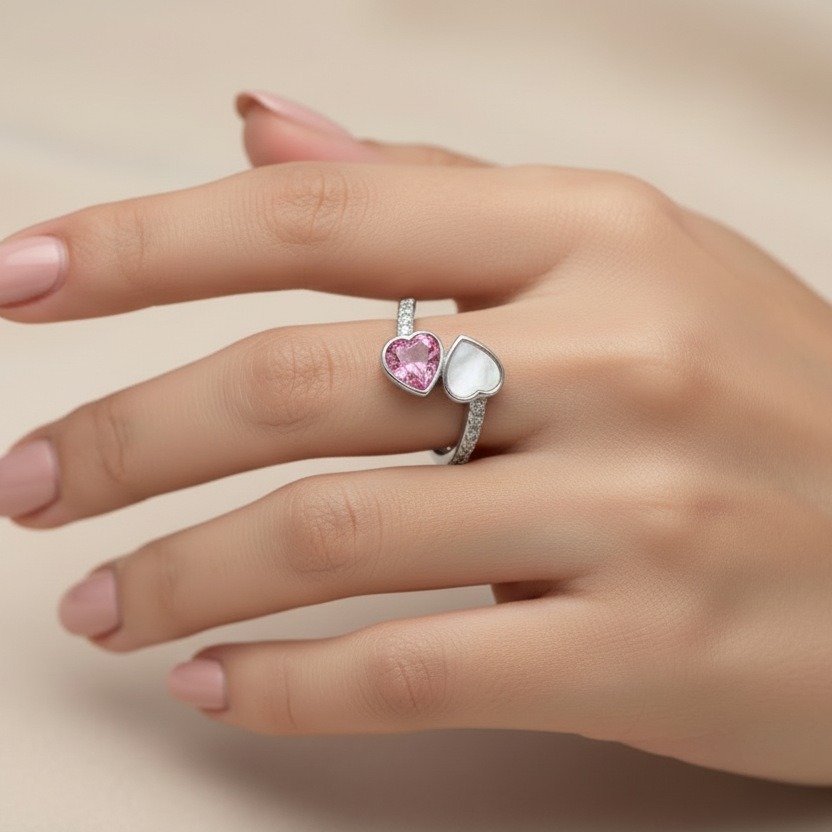 double heart ashes memorial ring in sterling silver, on a models hand