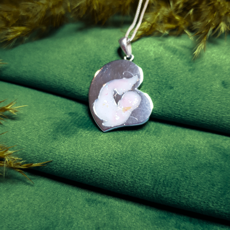 mother child ashes necklace on green velvet background