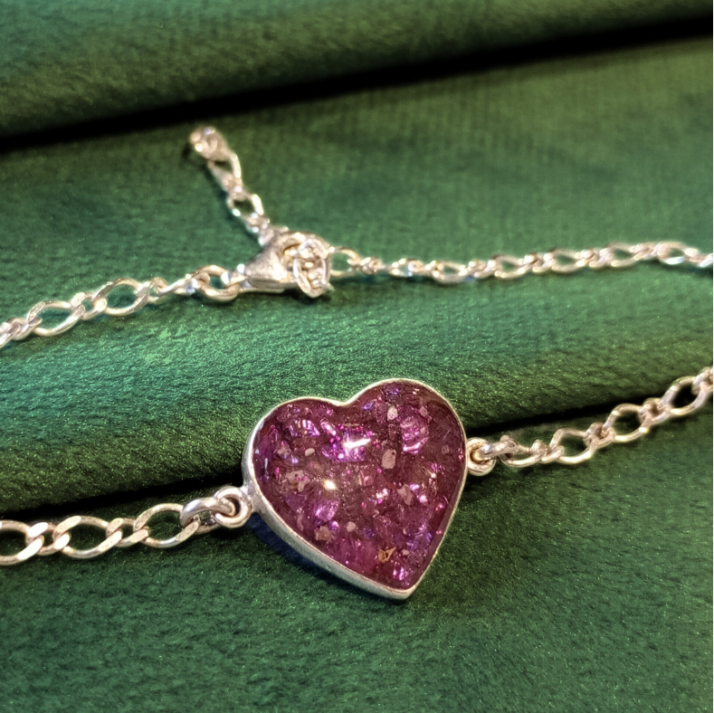 ashes heart bracelet on green velvet background