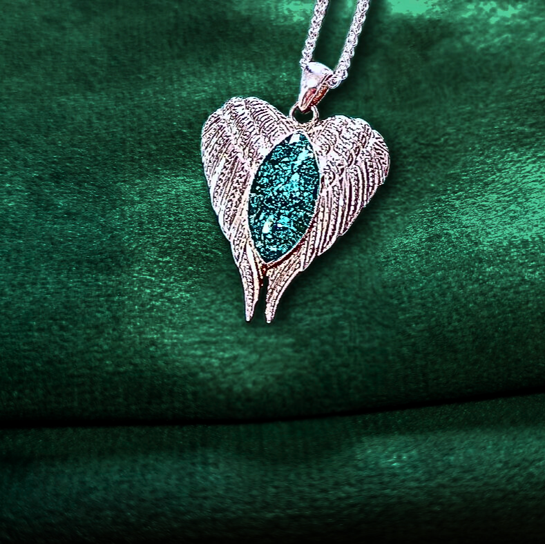 angel wings ashes memorial necklace on green velvet background