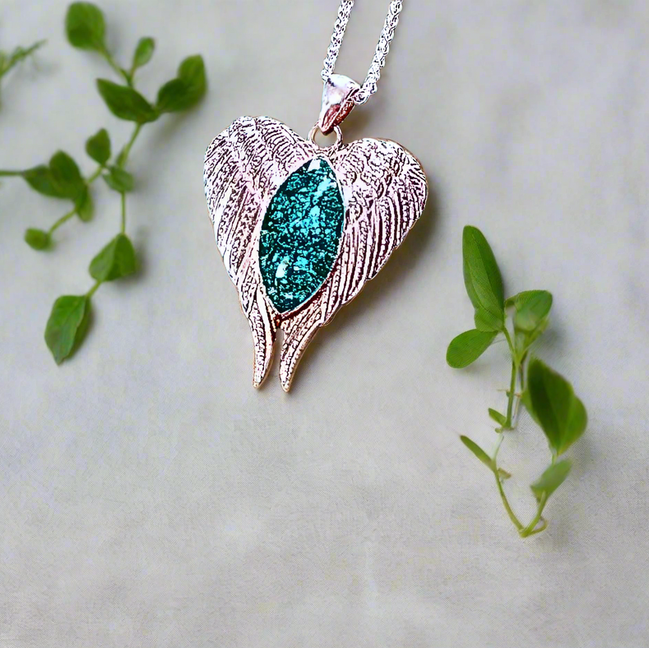 angel wings pendant in a heart shape featuring ashes resin centre