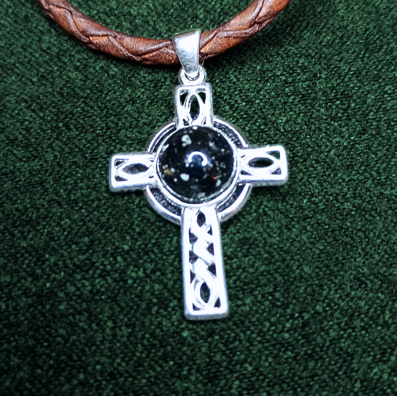 celtic cross memorial necklace on green background