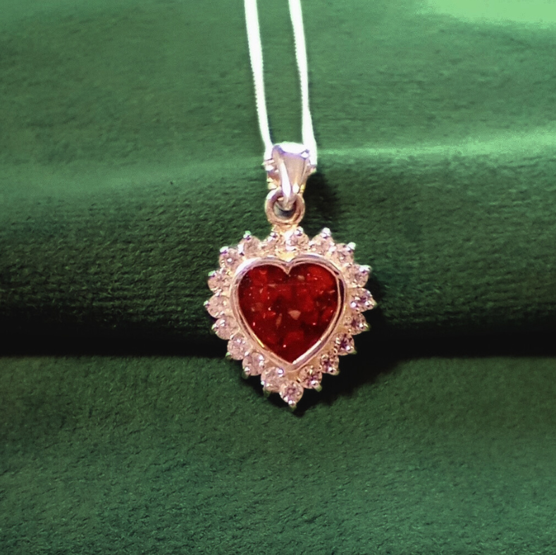 ruby heart ashes pendant on green velvet