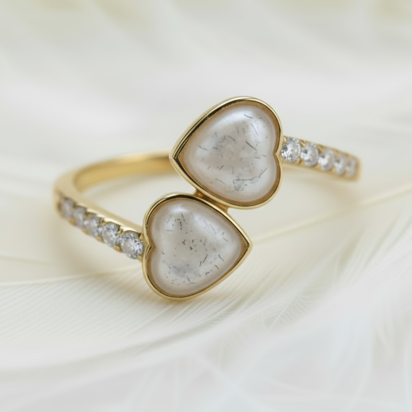 14ct gold ashes memorial ring with double sapphire cremations stones on a feather background