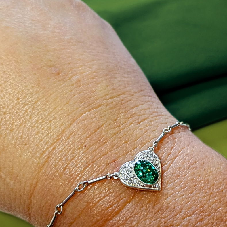 emerald heart ashes bracelet on arm