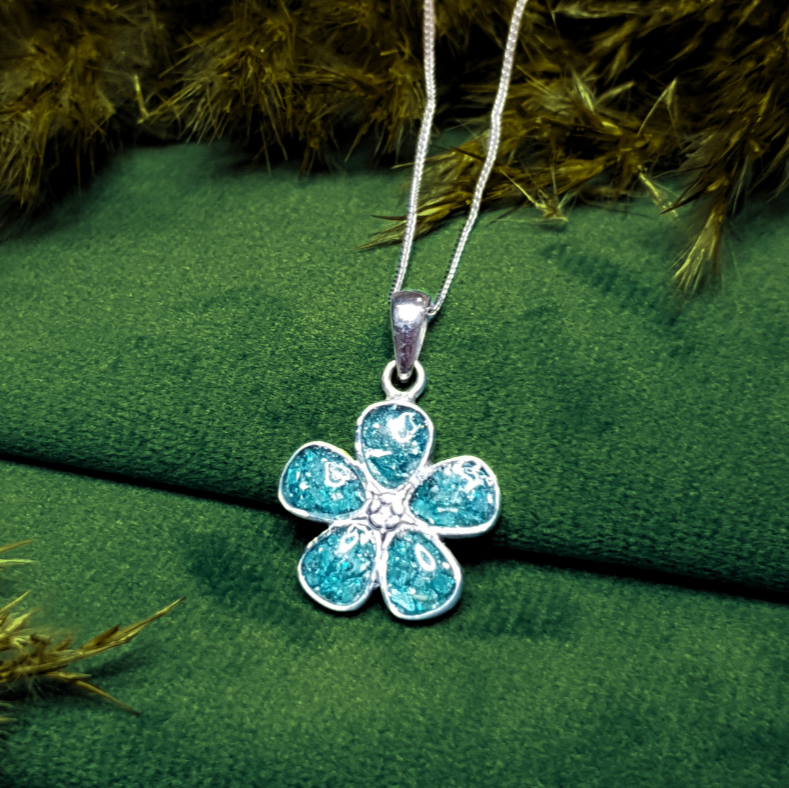 forget me not ashes memorial pendant on green velvet background