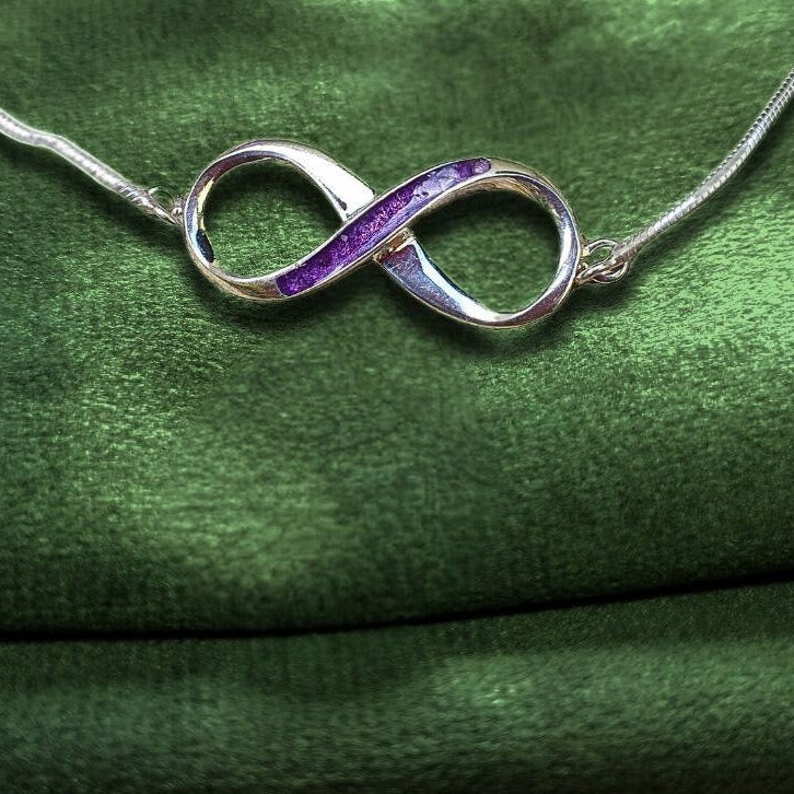 infinity ashes memorial bracelet on green velvet background