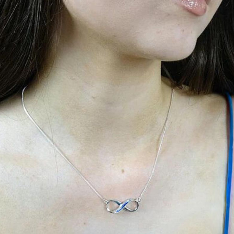 infinity ashes memorial necklace on model in blue sapphire