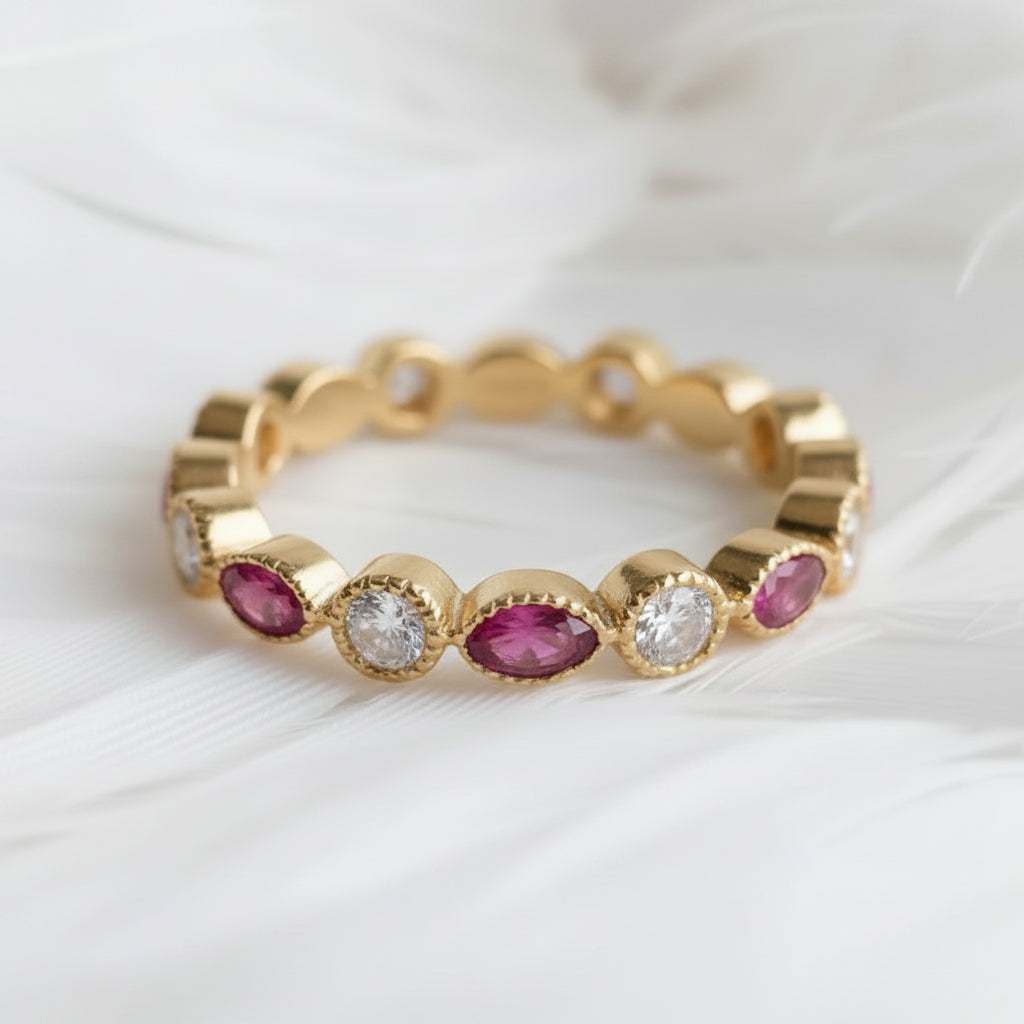 14ct or 18ct gold ashes eternity ring featuring amethyst ashes stones and genuine diamonds, displayed on a soft white feather background. 
