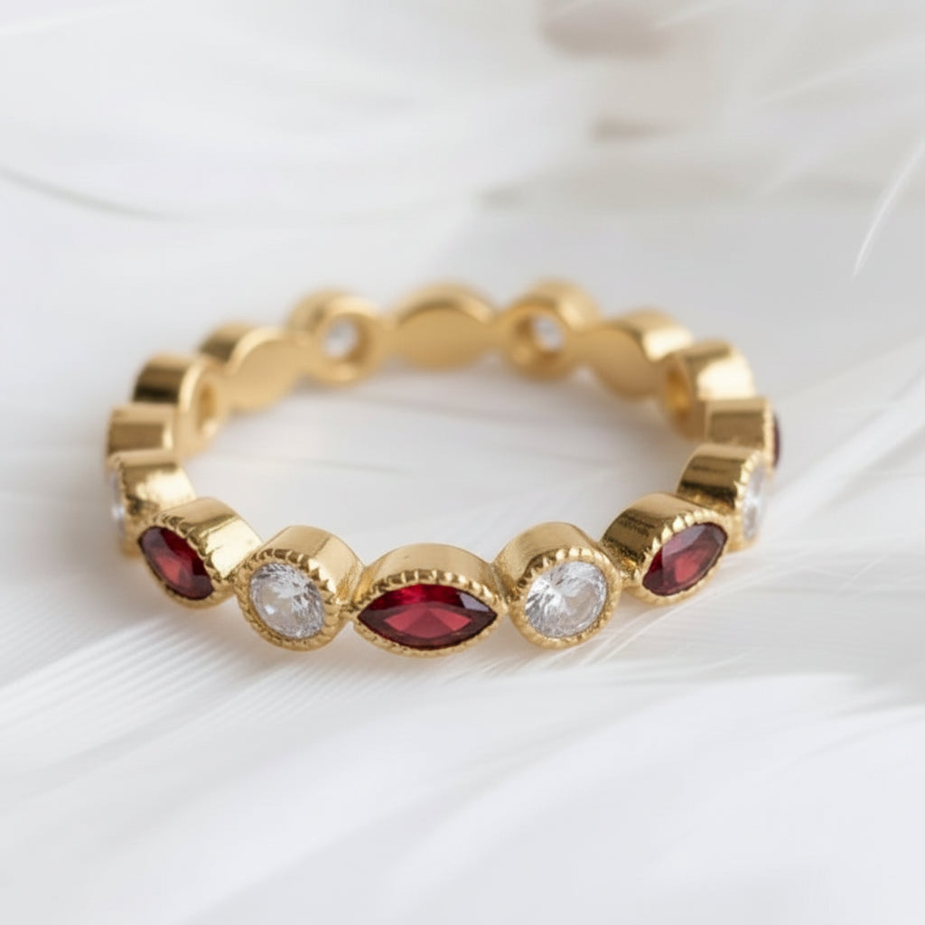 14ct or 18ct gold ashes eternity ring with garnet ashes stones and genuine diamonds, resting on a bed of soft white feathers.