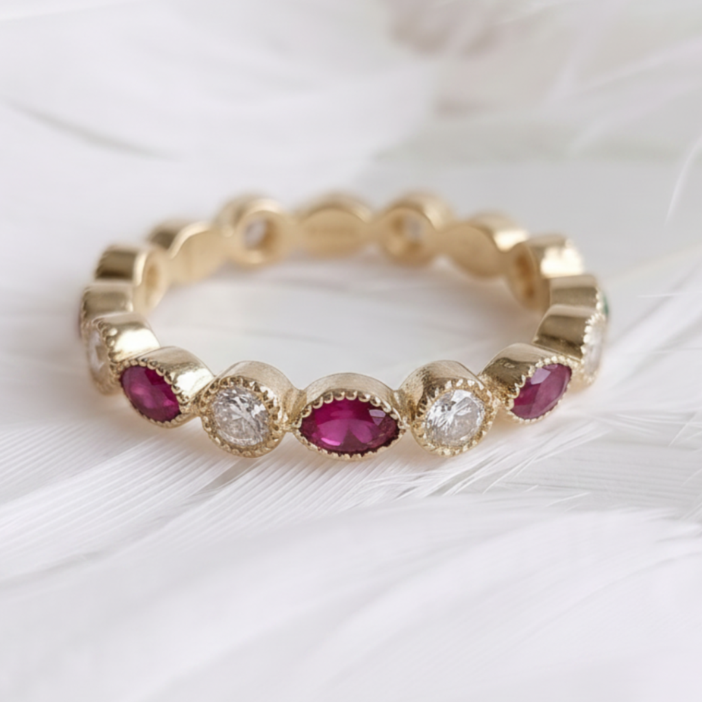 A 14ct or 18ct gold ashes eternity ring featuring marquis ashes stones choice of genuine birthstones including diamonds, displayed on a soft white feather background.