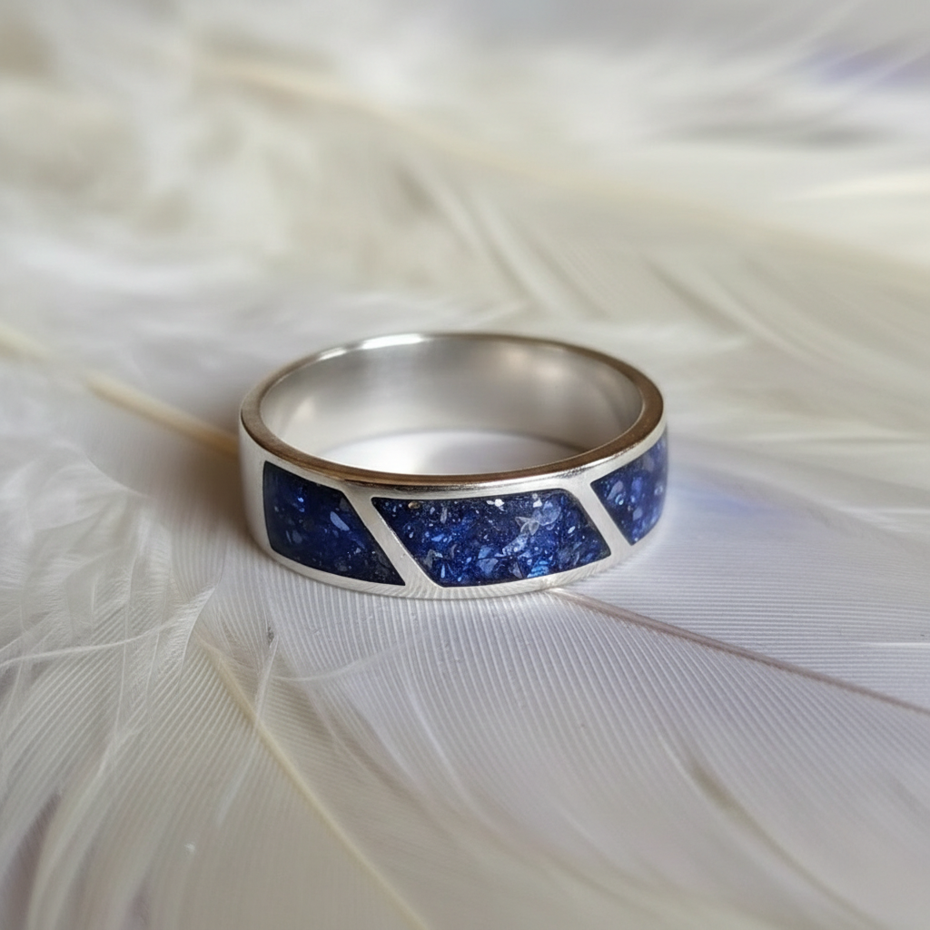 mens ashes cremation ring with 3 diagonal channels on a feather background