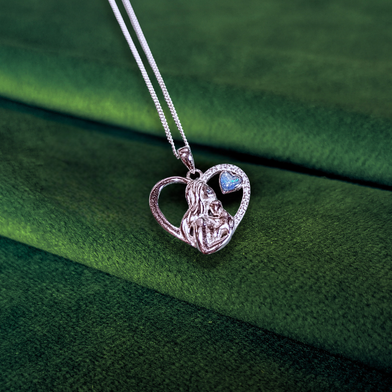 mother baby ashes necklace on green velvet background featuring blue opal