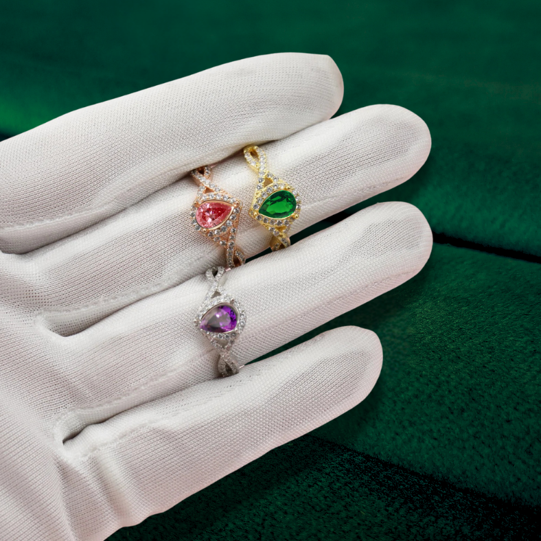 teardrop halo ashes rings in silver and gold on hand