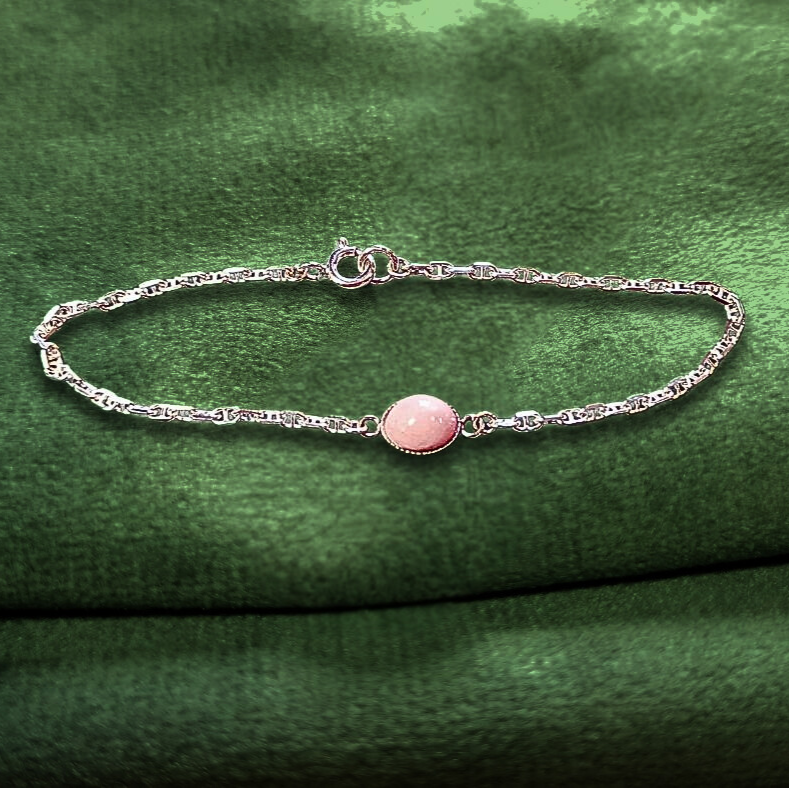 pink opal ashes bracelet on green velvet background