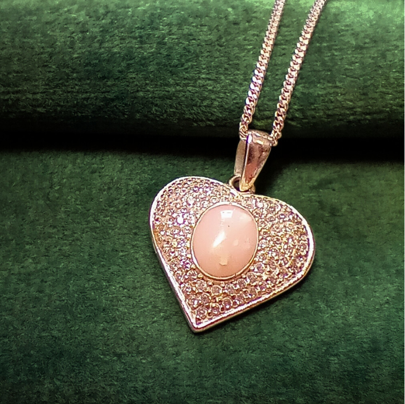 pink opal heart ashes  necklace on green velvet