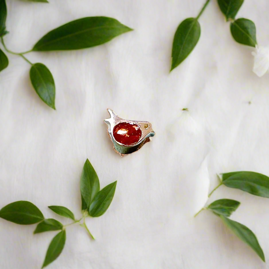 robin ashes charm on white background