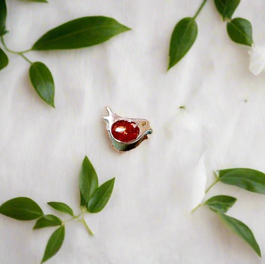 robin ashes charm on white background