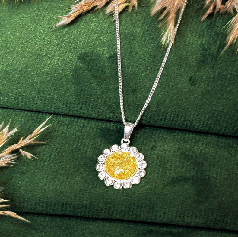flower halo ashes necklace on green velvet