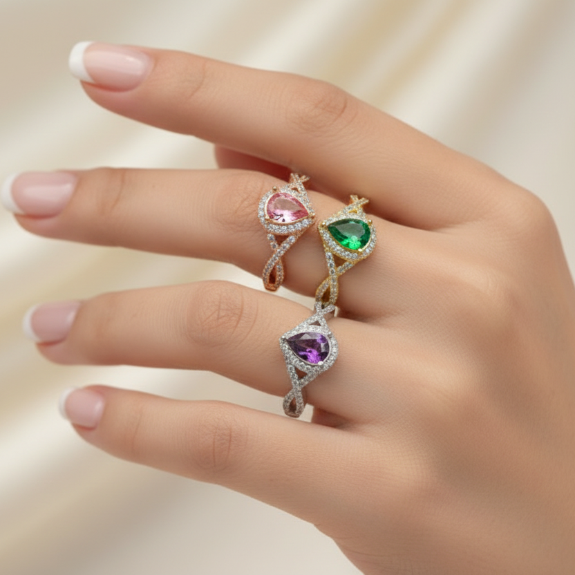 teardrop crossover rings for cremation ashes, in 14ct yellow white and rose gold on a models hand