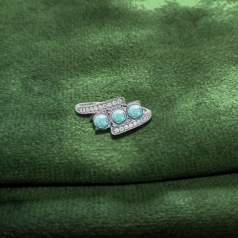 white gold ashes memorial ring on green velvet