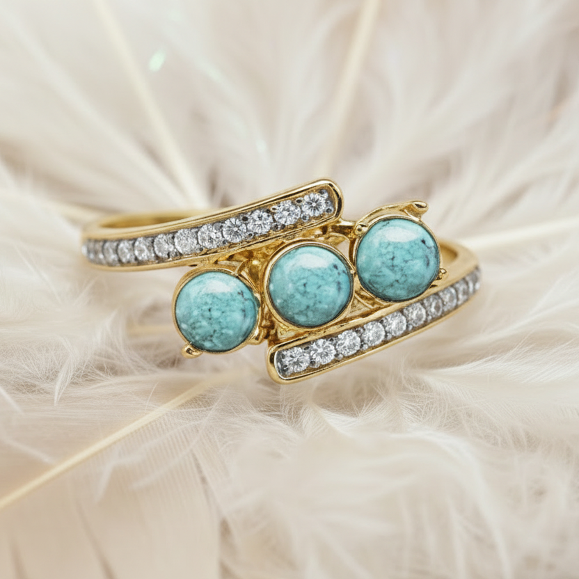 14ct yellow gold trilogy ashes ring set with turquoise memorial stones, on feather background